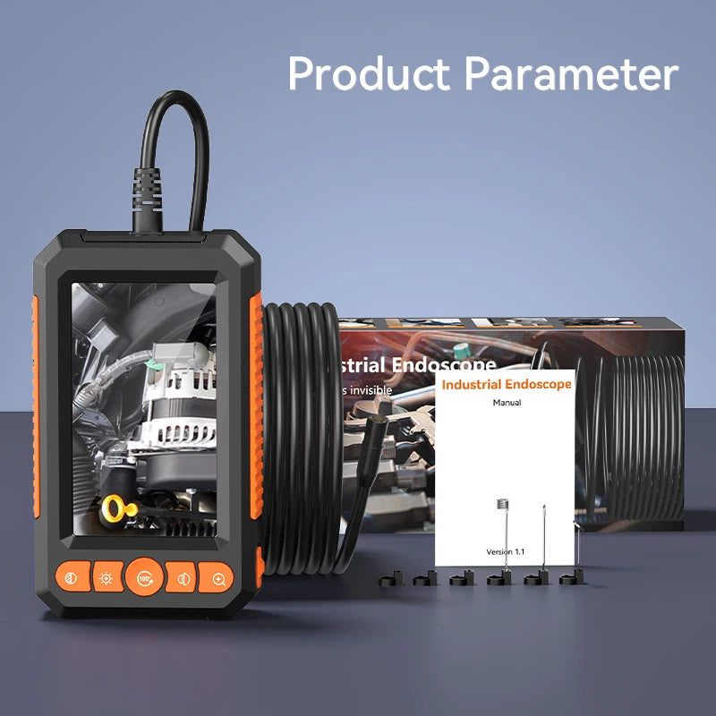 Black and orange dual-lens industrial inspection camera with screen, coiled cable, manual, and small accessories.