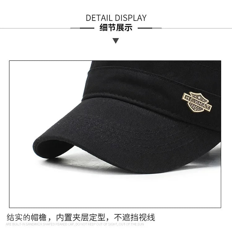 Close-up of a black cotton baseball cap with a structured peak and a gold-toned metal logo badge on the side.