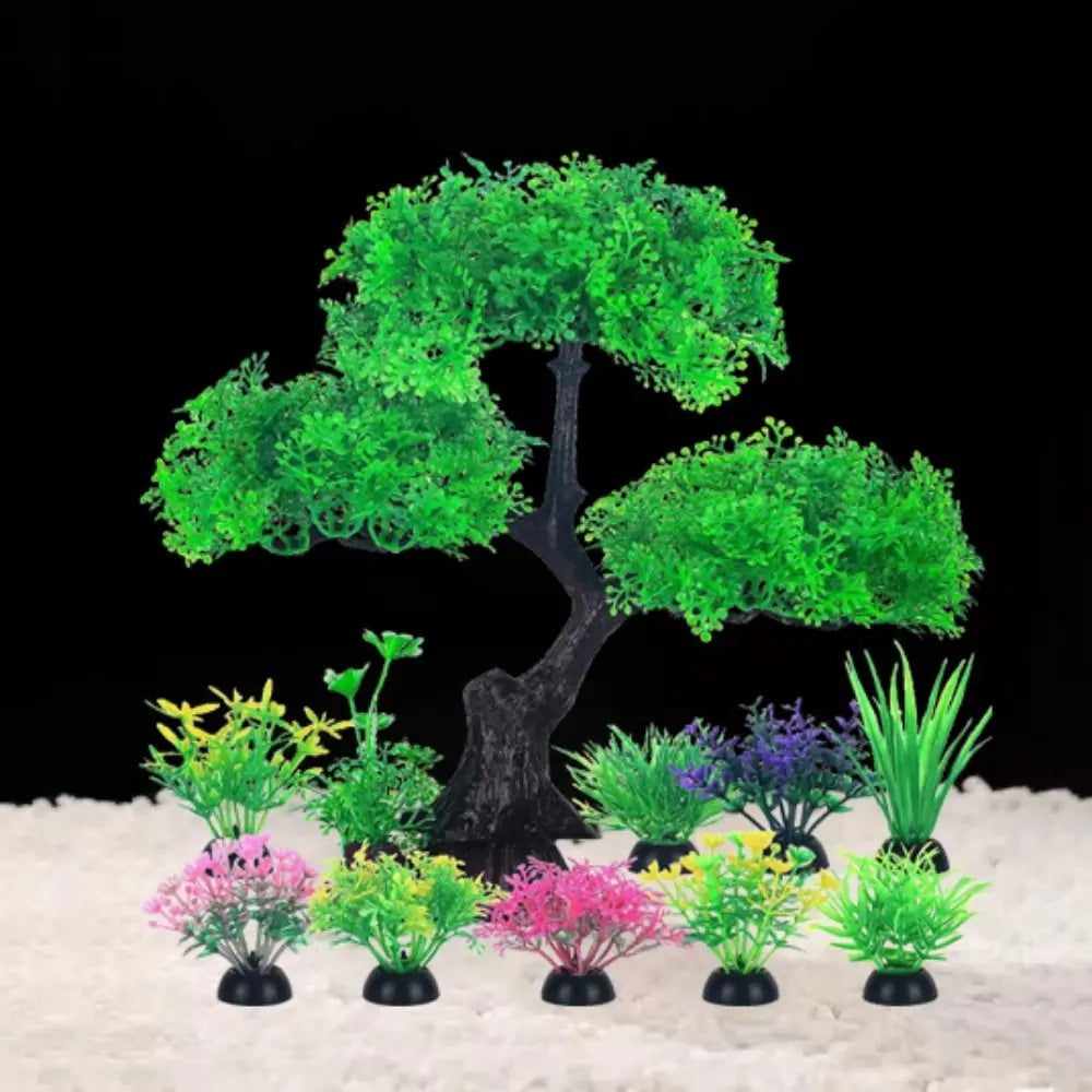 Artificial aquarium plants: one central green bonsai-style tree surrounded by ten smaller colorful water grass plants.