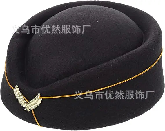 A black vintage-style pillbox stewardess hat, featuring a gold trim line and a decorative gold wing emblem.
