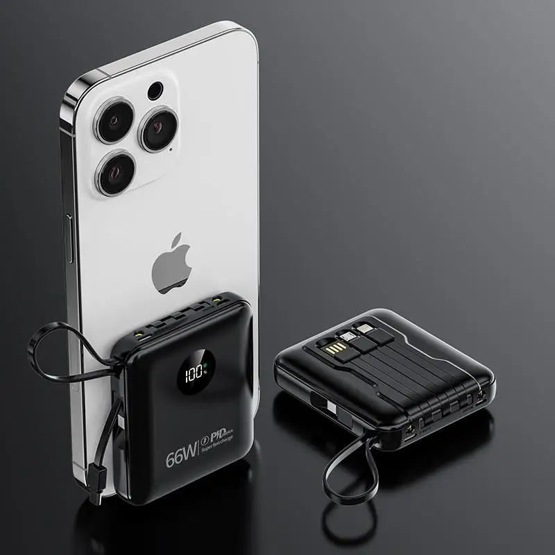 Black portable power bank with built-in cables, LED display and smartphone, shown on a dark reflective background.