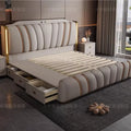 Modern cream upholstered bed with vertical channel stitching, gold trim, integrated headboard lighting, and side drawers.