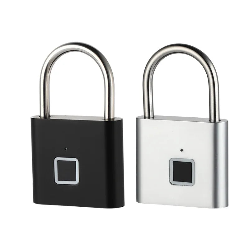 One black and one silver metal padlock with integrated square fingerprint scanners and steel shackles on a white back.