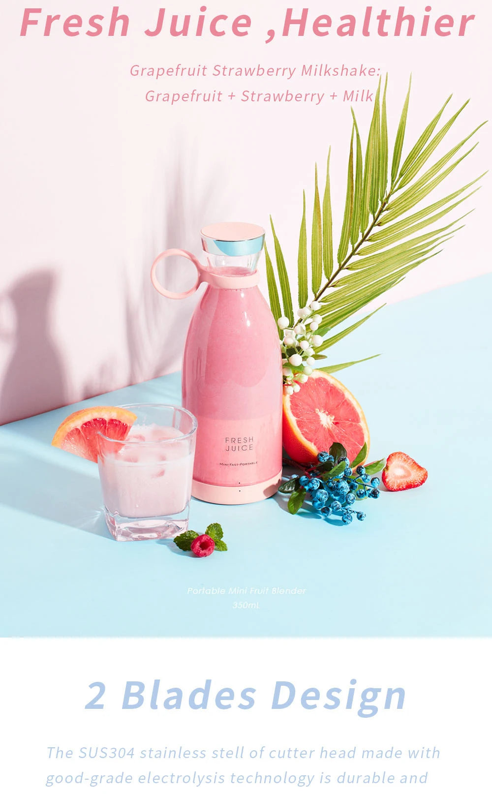 A pink portable mini blender with a glass of pink milkshake, grapefruit, and berries on a blue surface.