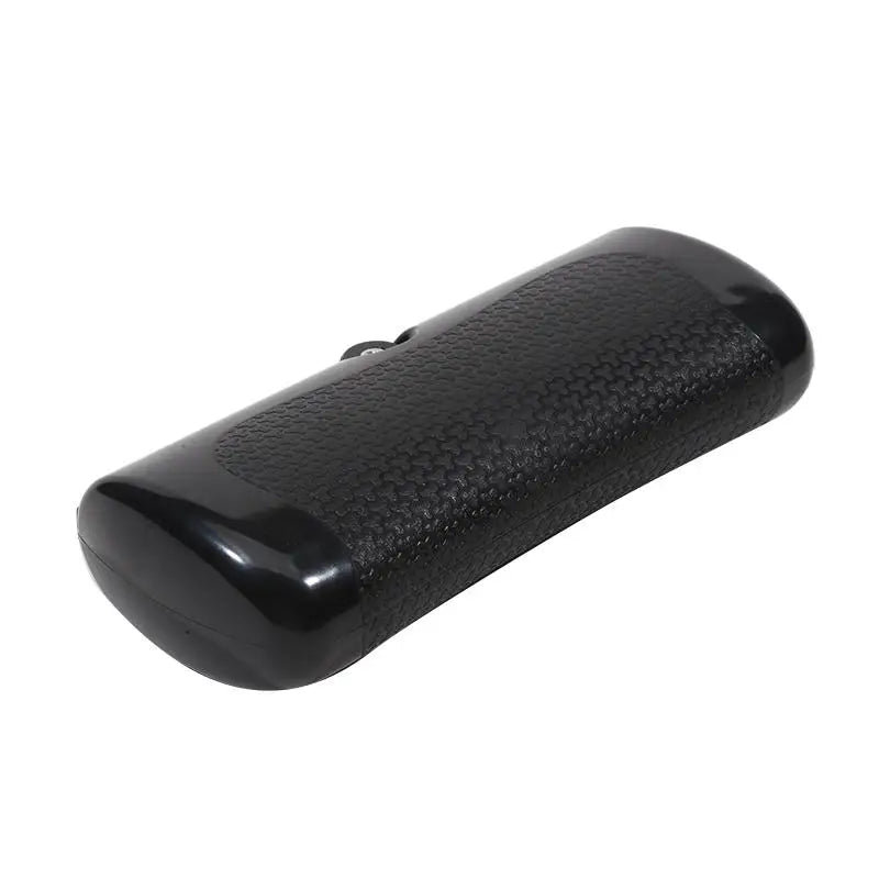 A black, rectangular hard glasses case with a textured, pebble-grain finish and smooth, glossy rounded ends.