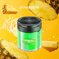 Cylindrical pineapple-scented car air freshener with a black top and vibrant green glitter body on a yellow background.