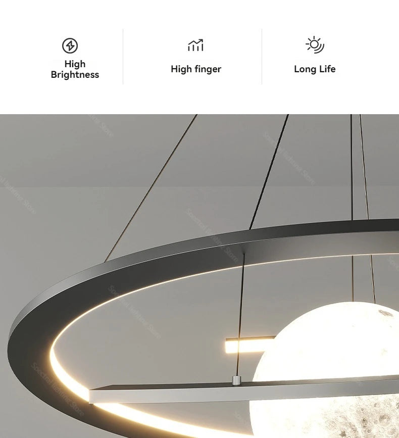 Modern black circular pendant lamp featuring a glowing, moon-textured spherical light suspended in the centre.