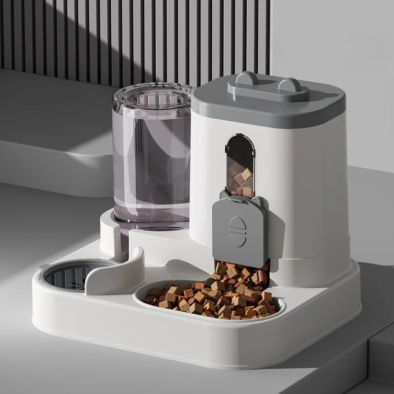 White and grey automatic pet feeder with a clear water tank and an integrated bowl filled with dry food kibble.