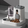 White and grey automatic pet feeder with a clear water tank and an integrated bowl filled with dry food kibble.