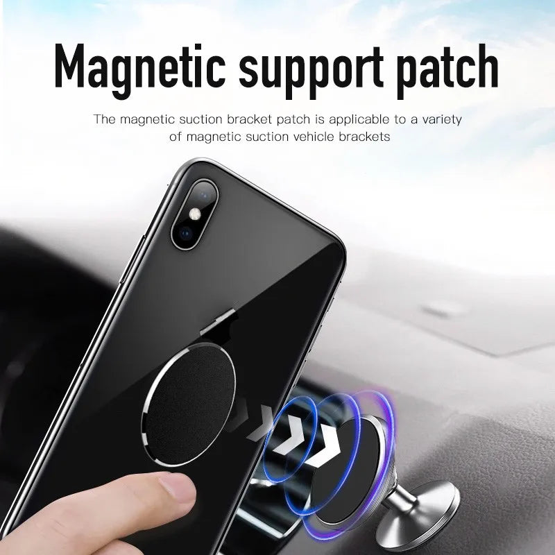 Black circular magnetic phone patch applied to the back of a smartphone, hovering near a silver magnetic car mount.