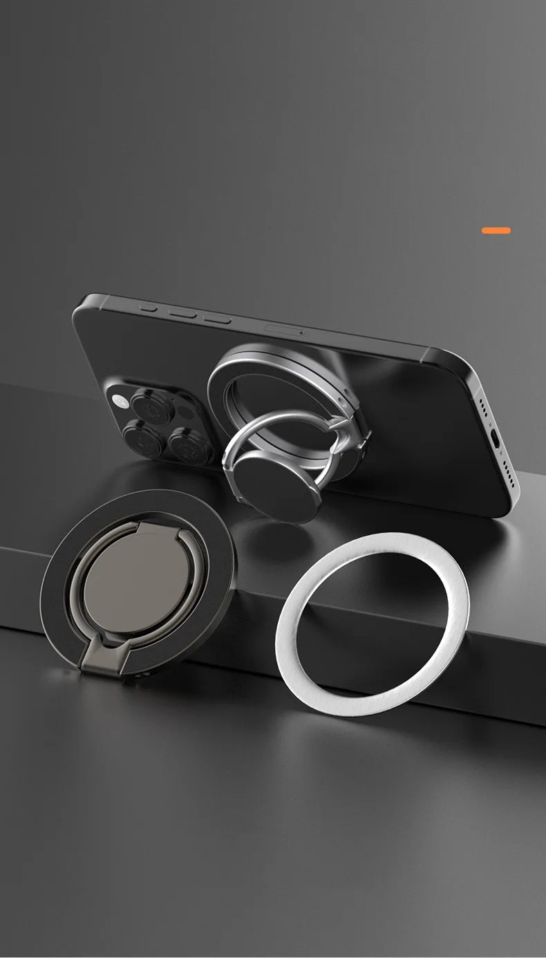Magnetic silver and black phone ring holders, shown on a smartphone and standing, with a separate white magnetic ring.