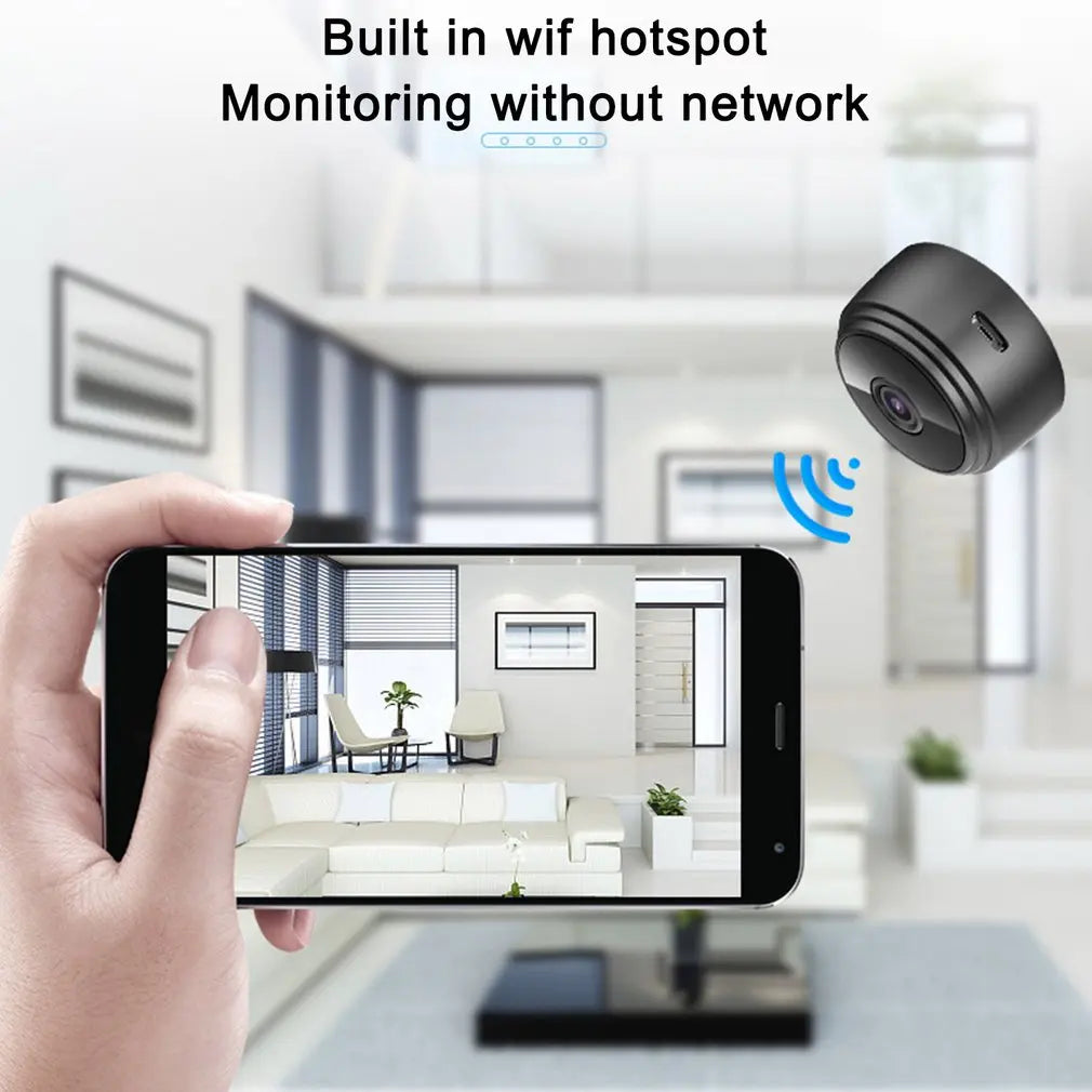 Small black plastic wireless security camera shown connected to a smartphone displaying a room view.