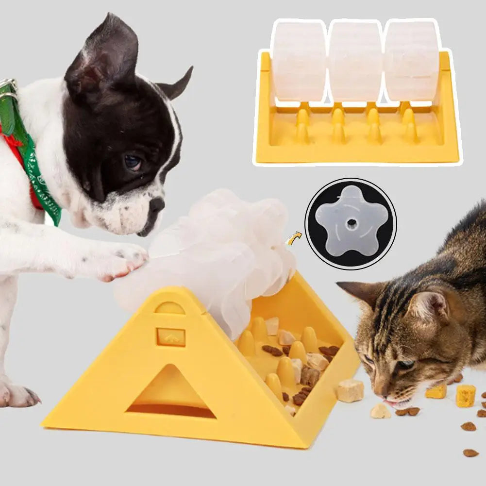 A yellow, triangular interactive puzzle feeder with clear spinning barrels, shown with a French bulldog and a cat.