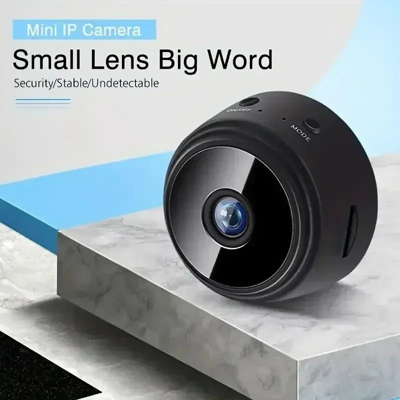 Small, round, matte black plastic mini IP camera with a center lens and top on/off and mode buttons.
