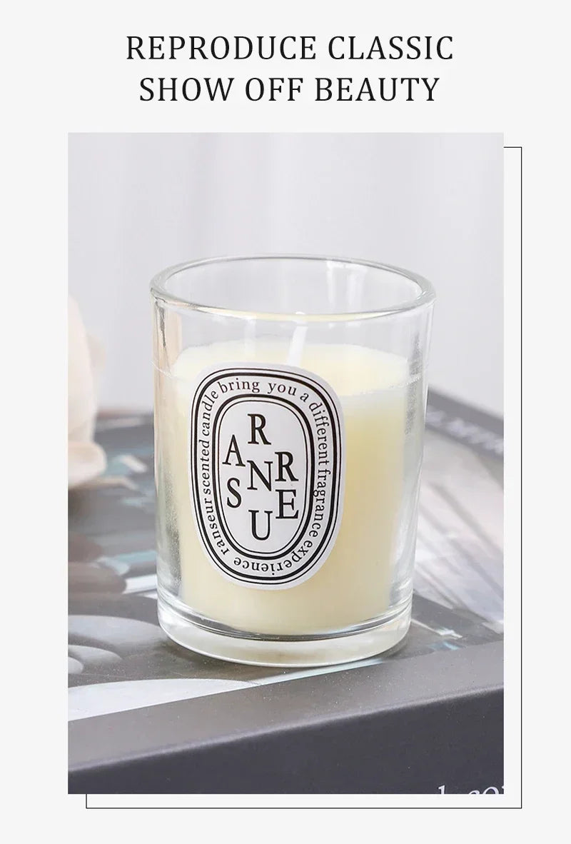 Off-white scented candle in a simple clear glass votive with an oval black and white label.