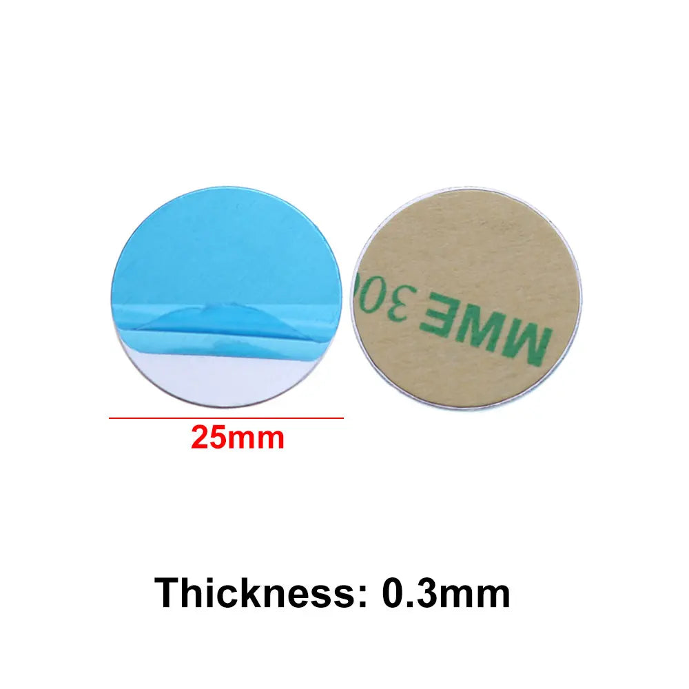 Two 25mm adhesive metal discs, one with a blue peel-off backing, the other with a brown adhesive side. 0.3mm thick.