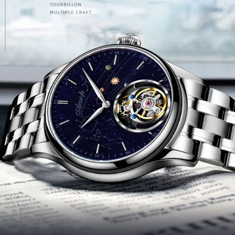 AESOP silver mechanical watch with a blue starry dial, constellation graphics, and a visible tourbillon.