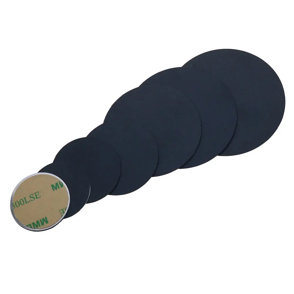 A stack of graduated black circular adhesive pads with tan peel-off backing, arranged in a row against a white background.
