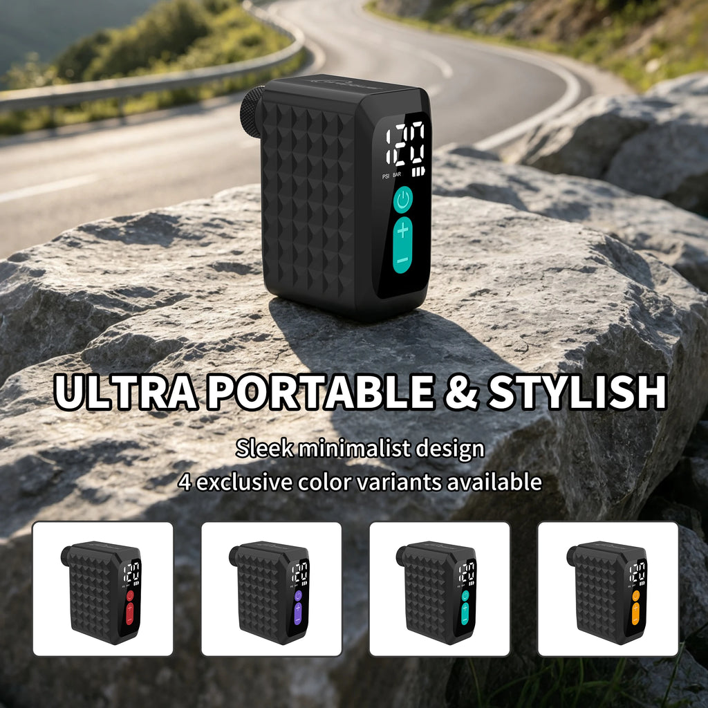 Black electric bike pump with digital gauge, textured sides, and teal power buttons on rock.