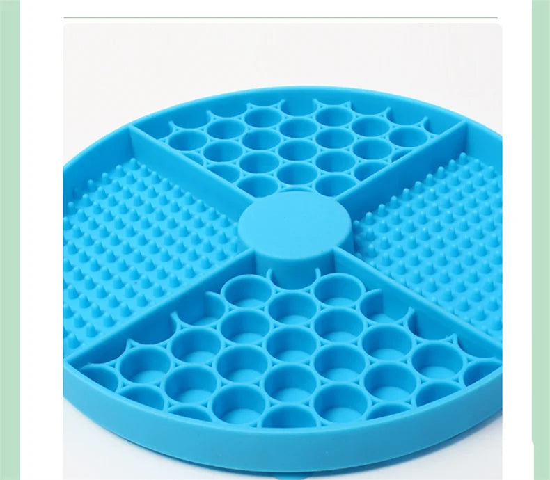 Round, blue silicone pet lick mat divided into four sections with honeycomb and textured bump patterns.