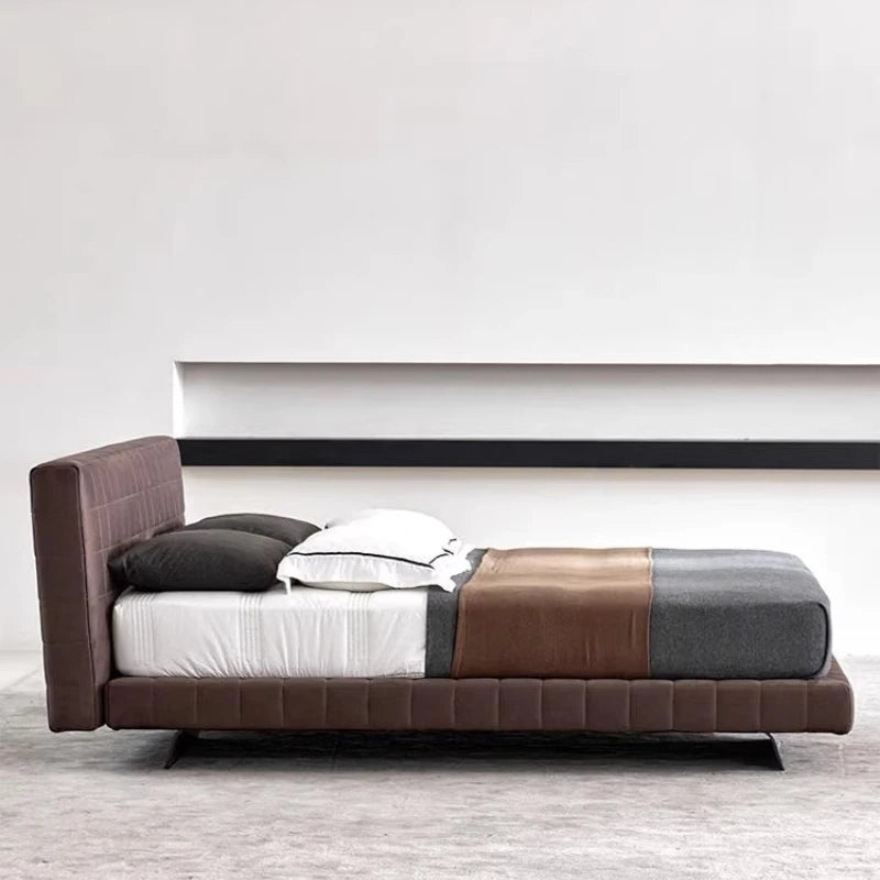 Modern Nordic-style brown upholstered bed frame with a grid-tufted headboard and low-profile base on thin dark legs.