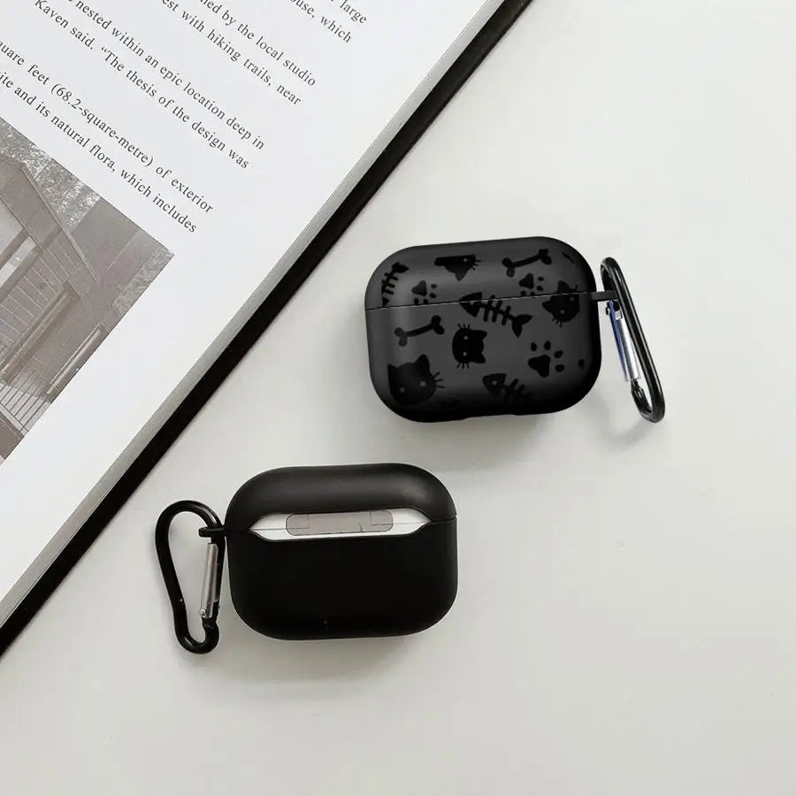 Black silicone AirPods Pro case with cat and fish bone pattern, featuring a metal carabiner clip.