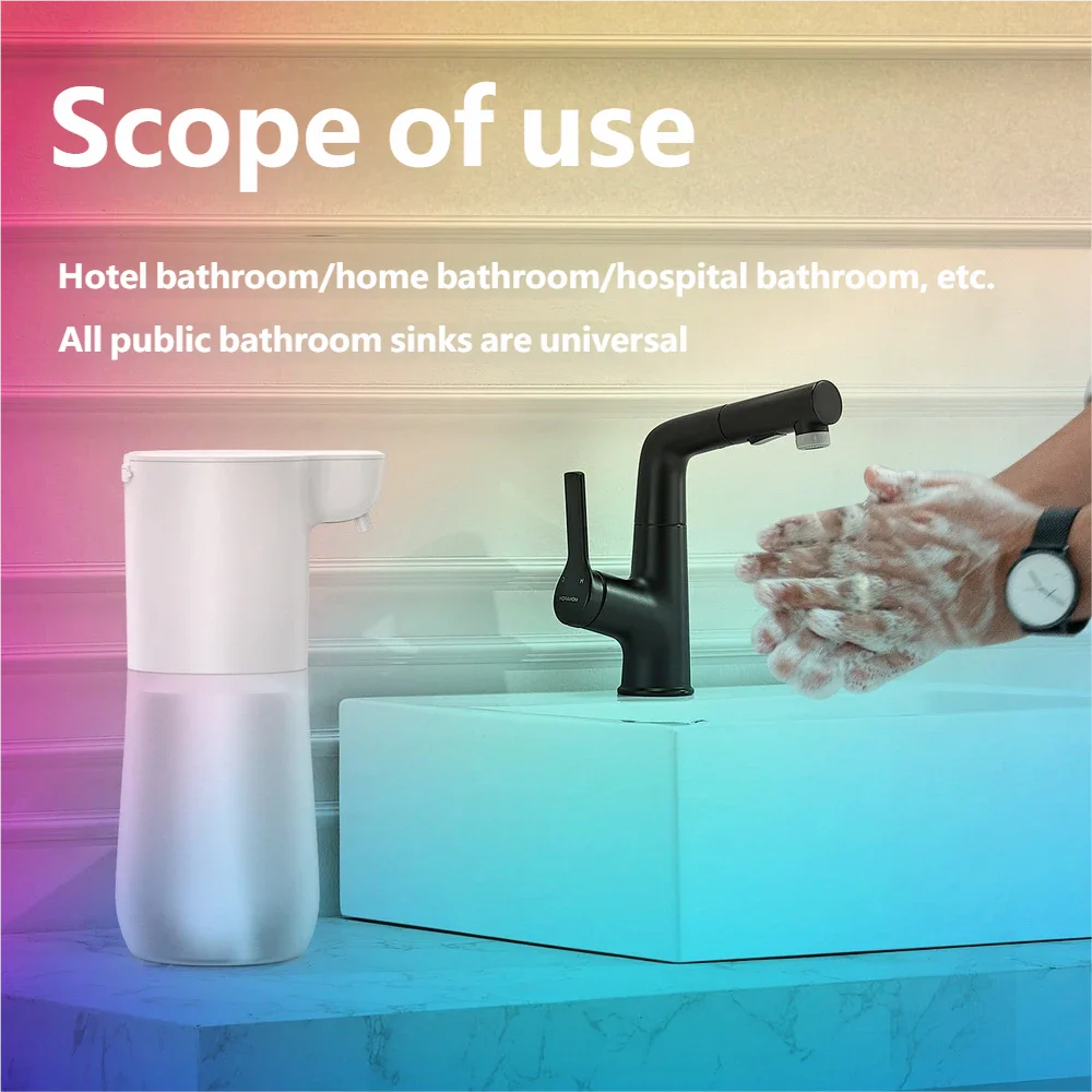 White, automatic touchless foam soap dispenser next to a modern sink tap and someone washing their hands.