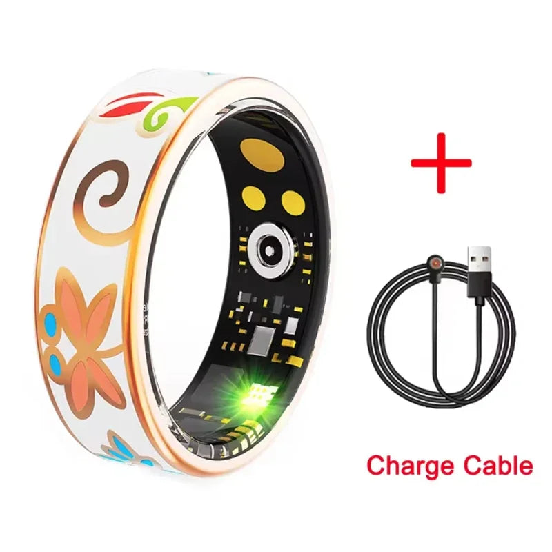 White smart fitness ring with colourful floral patterns, rose gold edges, internal sensors, and a magnetic charge cable.
