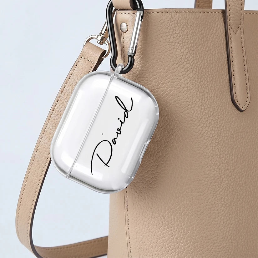 Clear protective AirPods Pro case with 'David' name personalisation, featuring a black carabiner clip attached to a bag.