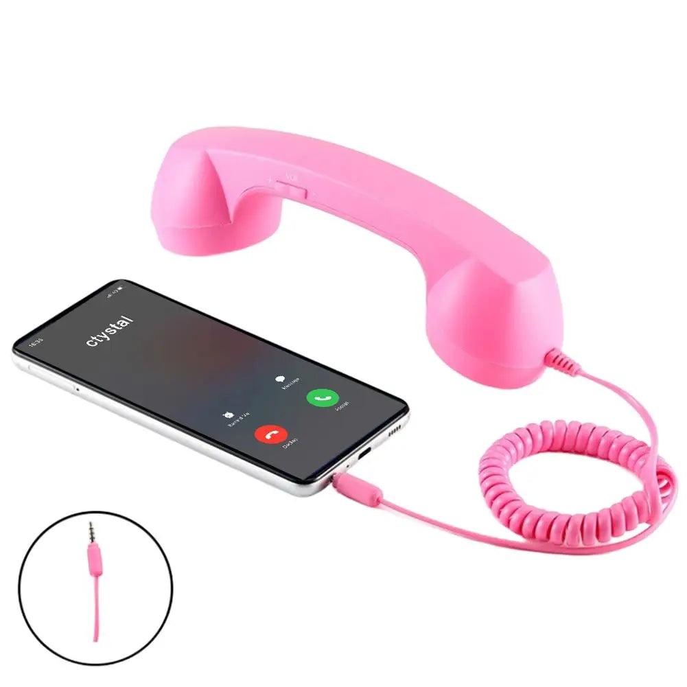 Bright pink retro-style telephone handset with a coiled cable, plugged into a smartphone for hands-free calls.