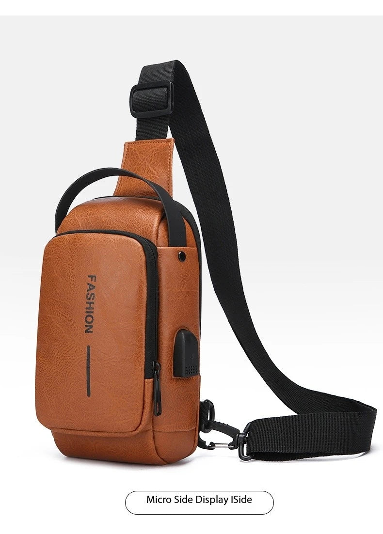 Tan faux leather crossbody sling bag with a black adjustable strap, top handle, and built-in side USB charging port.