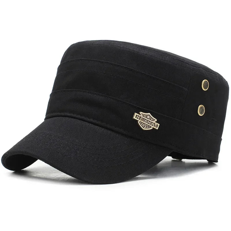 Black cotton military-style cadet cap with a flat top, short peak, and decorative gold-tone metal side accents.