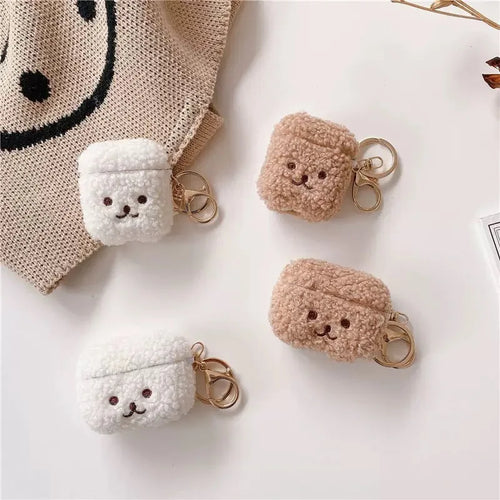 Fluffy teddy bear-style AirPods cases in white and brown, featuring gold keychains. Compatible with AirPods.