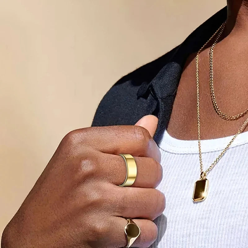 Close-up of a hand wearing a sleek, polished gold smart fitness ring on the index finger.