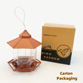 Brown, hexagonal gazebo-style bird feeder with clear panels, hanging wire, and its cardboard packaging box.