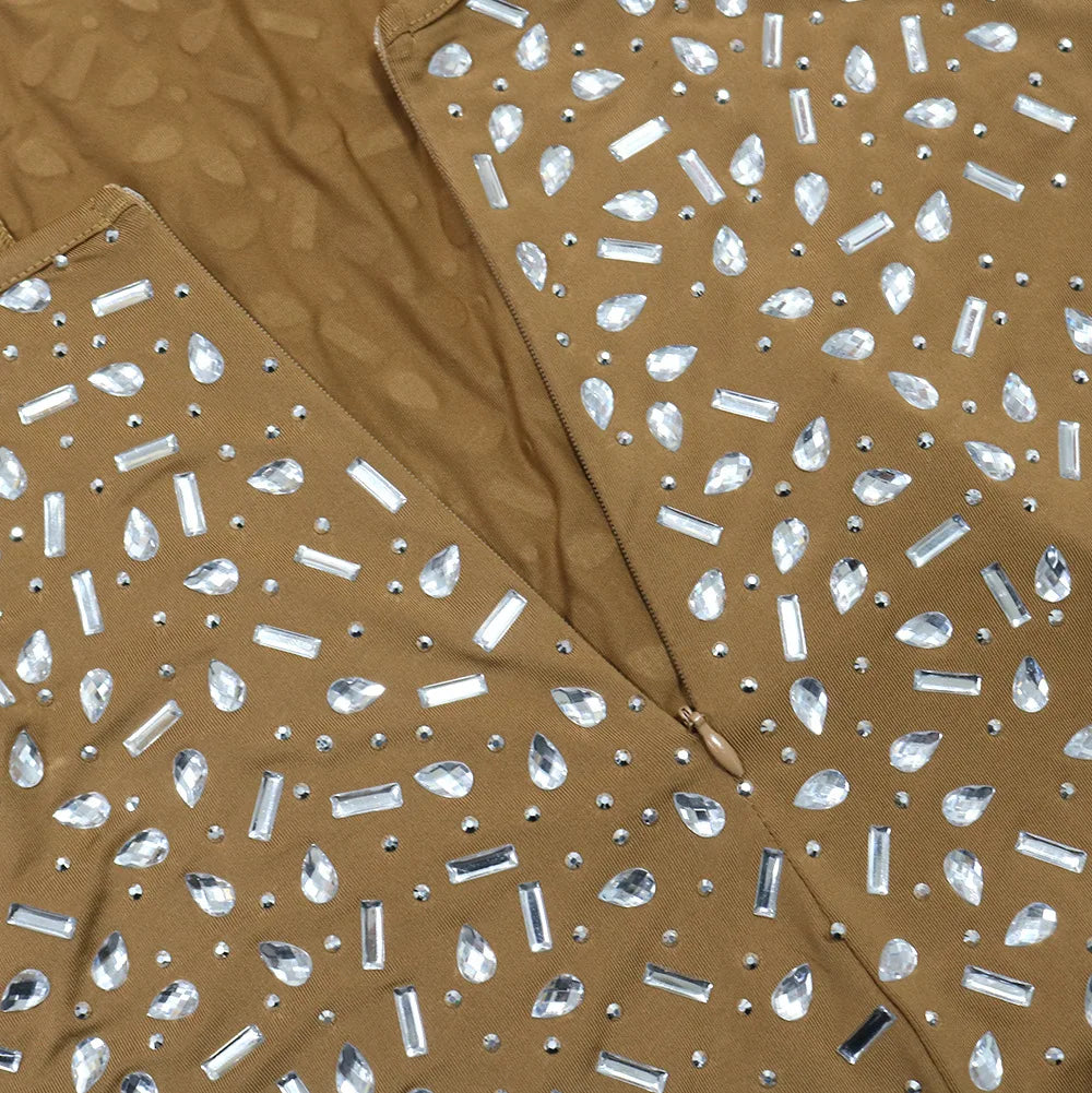 Tan bodycon dress embellished with scattered clear rhinestones in teardrop and rectangular shapes.