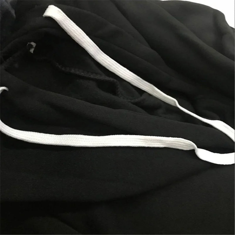 Close-up of a black hoodie featuring a soft fabric texture and contrasting white drawstring cords.