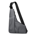 Grey anti-theft triangle chest bag with a sleek, minimalist design, adjustable strap, and side zip fastening.