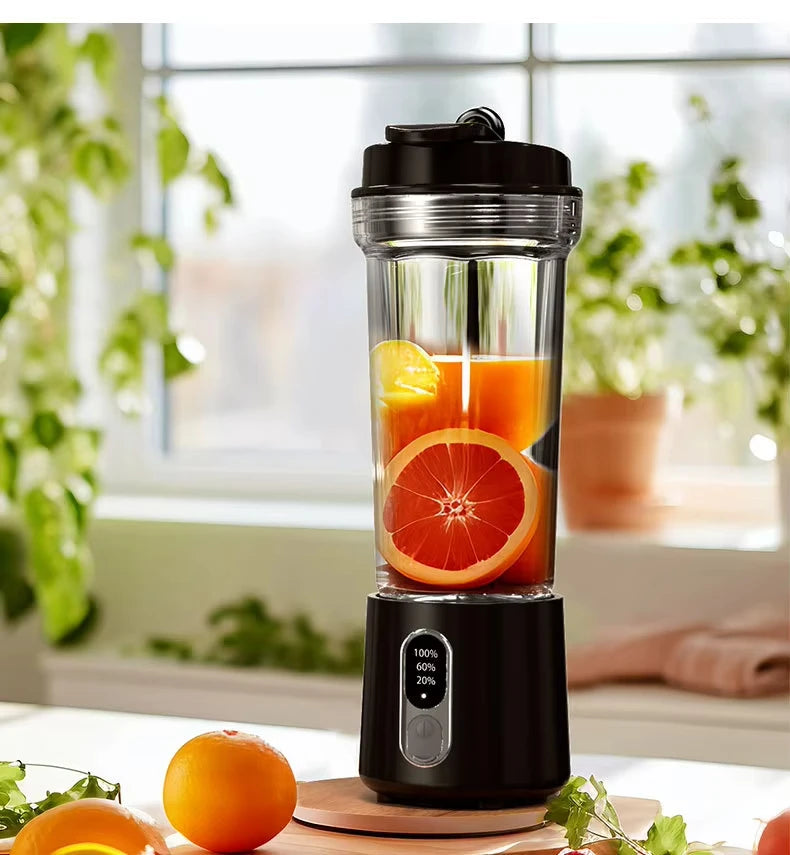 Portable black blender with a clear cup containing orange slices and juice, featuring a digital battery display.
