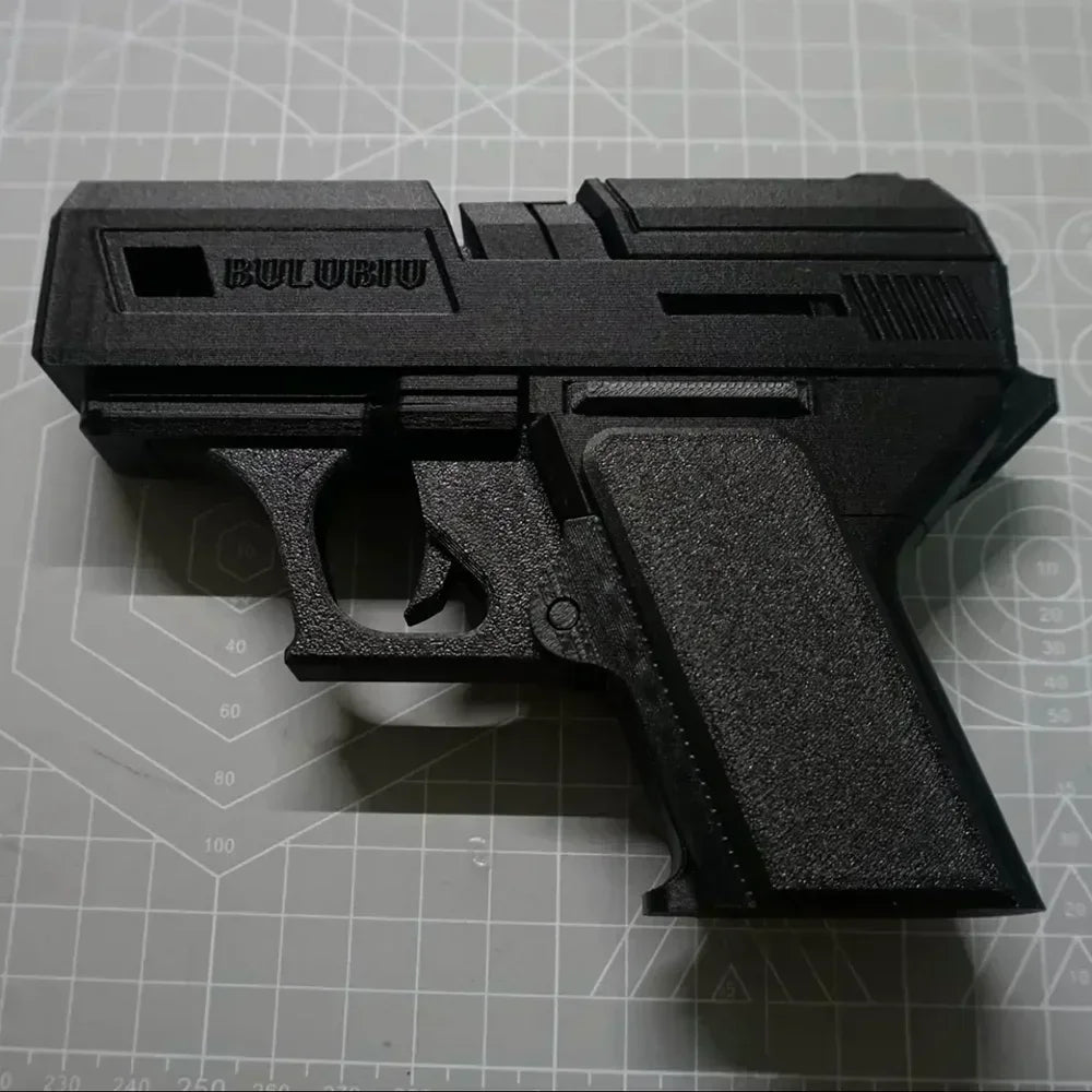 Matte black, textured 3D-printed gun-style AirPods case on a cutting mat.