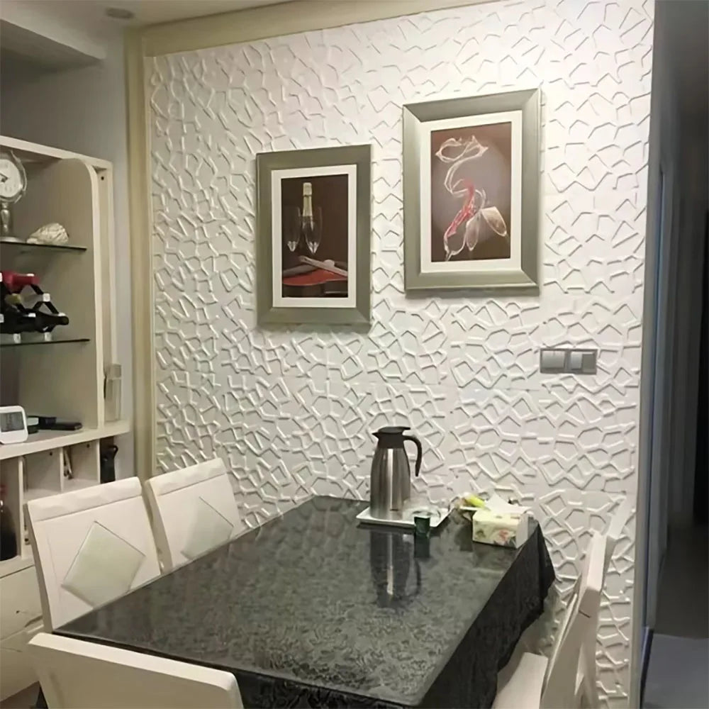 White 3D self-adhesive wall tiles with a geometric textured pattern, featured as a stylish dining room feature wall.