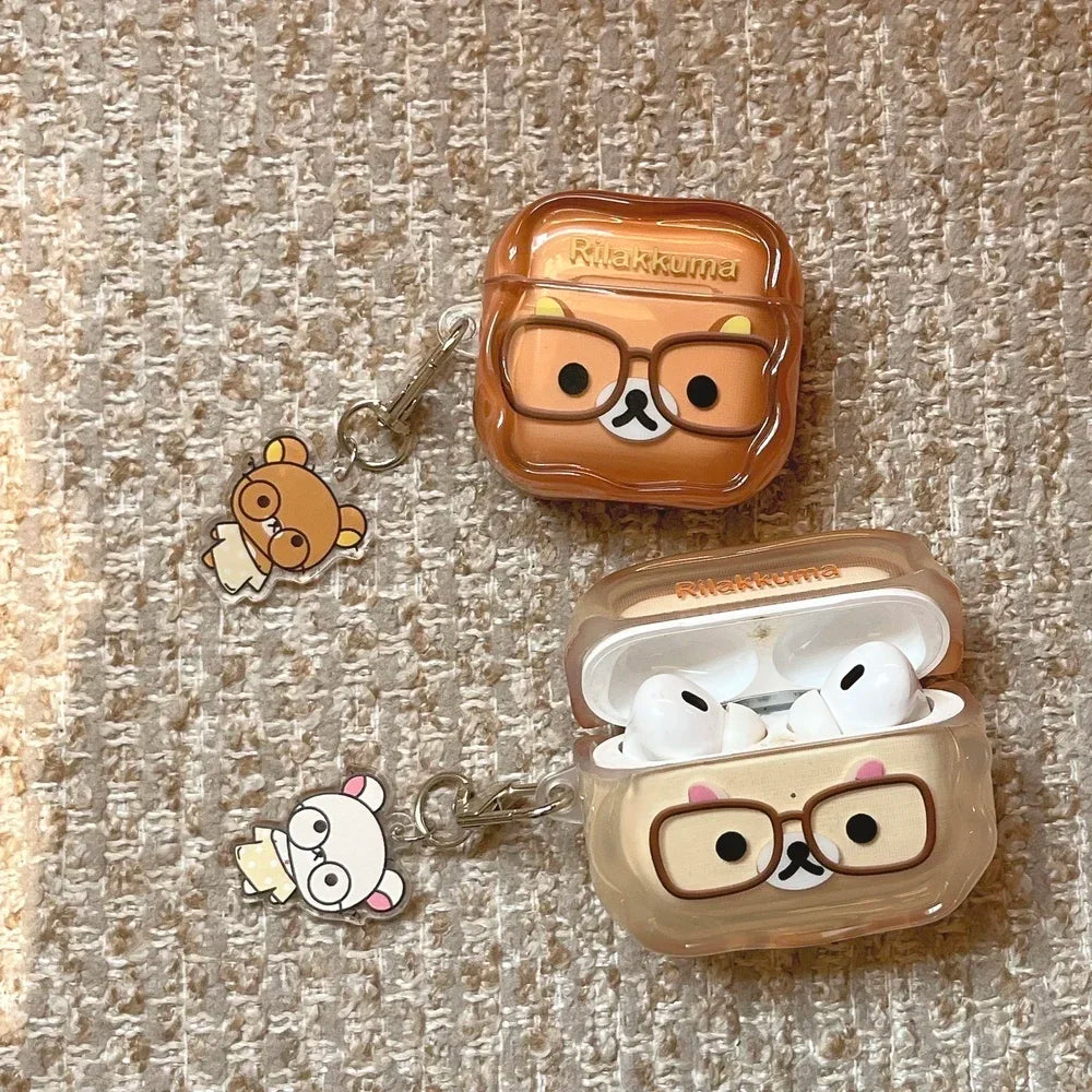 Clear Rilakkuma-themed silicone cases for AirPods Pro, featuring character charms and glasses detail.