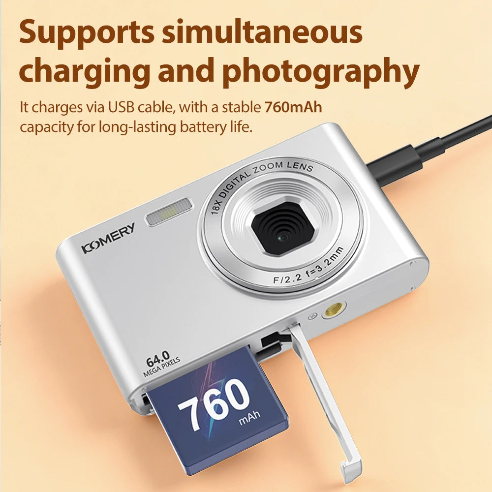 Silver digital camera with 64MP lens, 18x zoom, and 760mAh rechargeable battery, shown with a USB charging cable.
