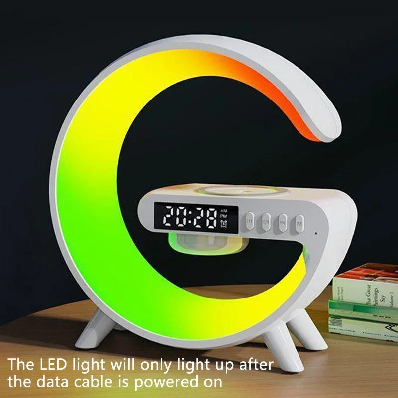 G-shaped white desk lamp with RGB lighting, digital clock, built-in Bluetooth speaker and wireless charging pad.