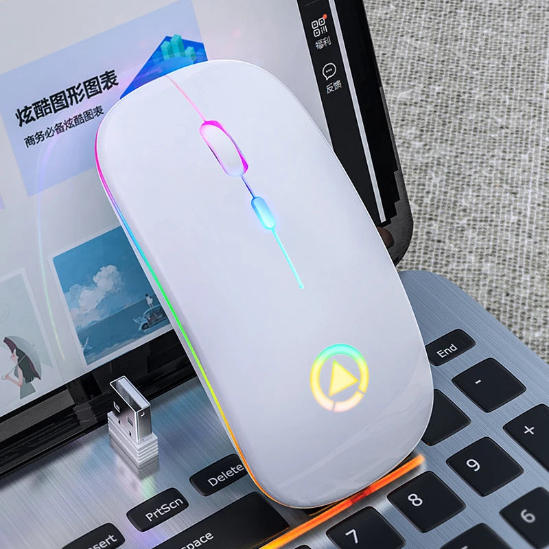 Sleek, white wireless ergonomic mouse with vibrant RGB lighting and a glowing play icon on a laptop keyboard.