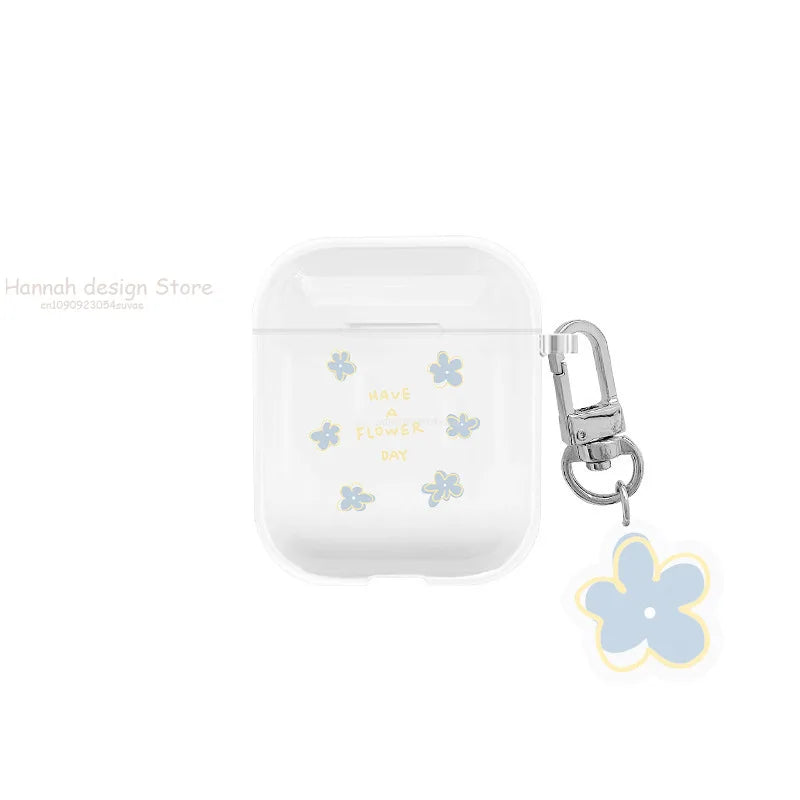 Clear AirPods case with blue flower print, "Have a flower day" text, and matching charm keyring.