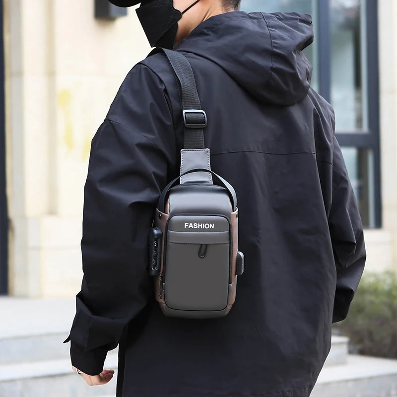 A person wearing a grey, sleek anti-theft crossbody chest bag with an integrated USB charging port.