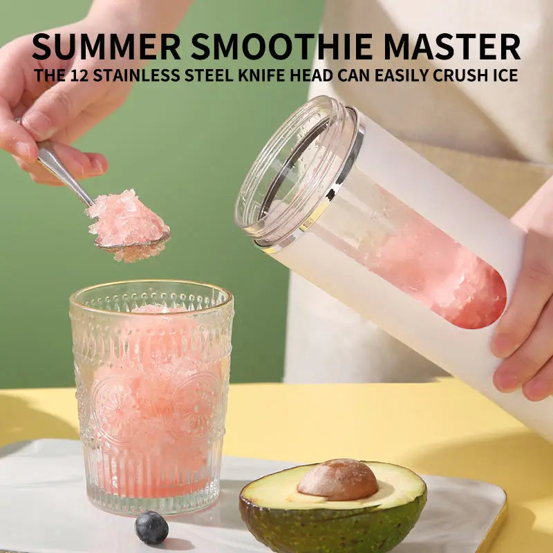 A person pouring crushed pink ice from a sleek white portable blender into an ornate glass. Avocado on the table.