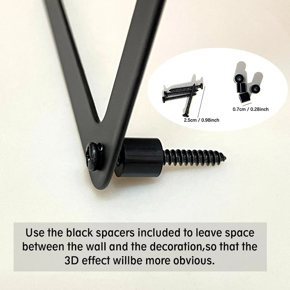 Close-up of matte black metal wall art hardware, including screws and spacers for a 3D floating effect.