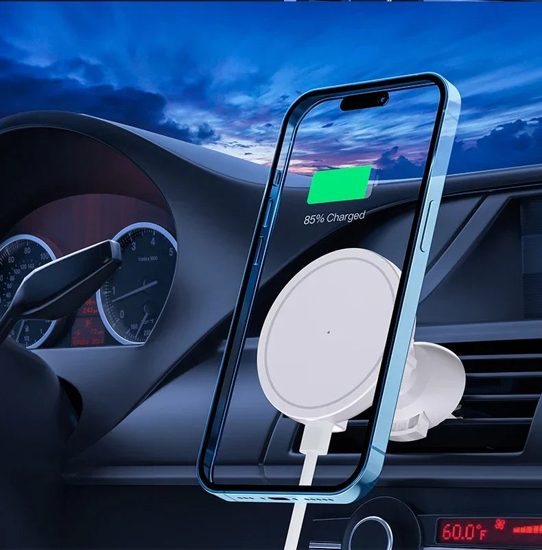 White magnetic car phone mount attached to a vehicle air vent, holding a blue smartphone charging at 85%.